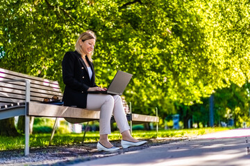 Fototapeta premium Coffee break - beautiful woman resting in city park 