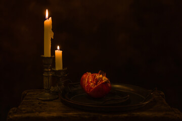 Dark still life with pomegranate