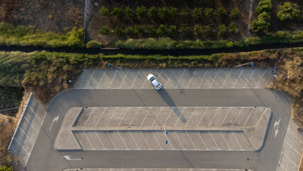 White Car alone in a parking from the air
