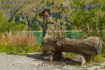 Wooden water fountain in the mountains of the alpine valleys