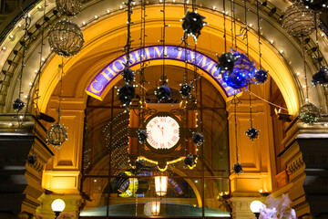 Christmas vintage clock with text Happy New Year on the city street.