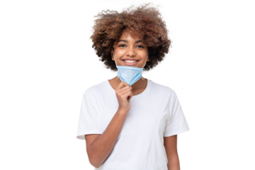 Smiling african school girl taking off face mask after the end of lockdown, isolated
