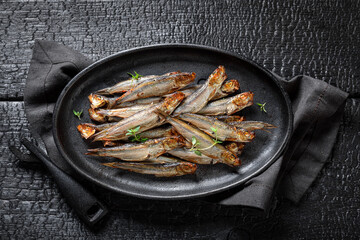 Tasty smoked sprats marinated with spices and salt.