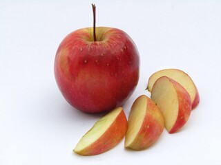 Red apple with half sliced apple on white background 