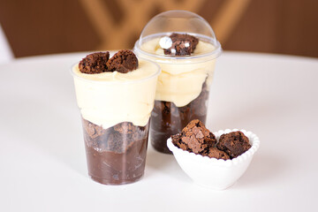 two cakes in the pot and a bowl of brownie pieces