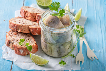 Tasty and healthy pickled fish served with bread and coriander.
