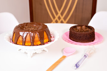 a carrot cake with chocolate frosting and a chocolate cake with brigadeiro frosting
