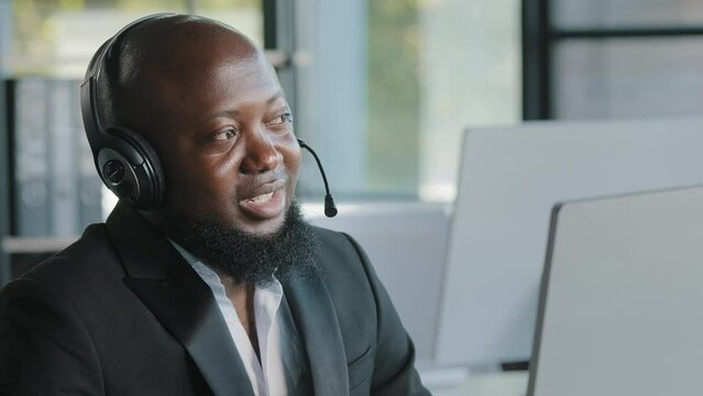 Businessman african manager in headphones with microphone talking by video conference call customers service support agent consulting client on computer remotely job interview business teleconference