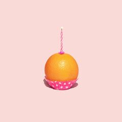 Healthy cupcake on pastel light pink background. Minimalistic food concept. Creative birthday composition.