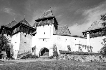 Fortified church in Viscri village, Brasov country, Transylvania, Romania; medieval saxon fortified evangelical church in black and white
