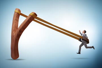 Businessman being launched from slingshot in career concept