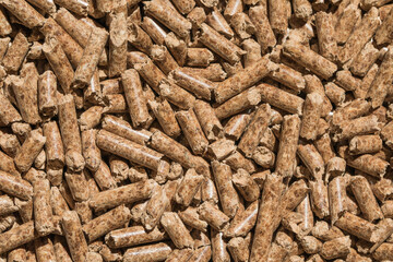 Wood pellets background, pattern. Pellets of natural wood close up. Ecological heating, energies renewable Biofuels.