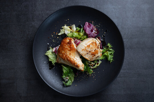 Grilled chicken breast with salad on plate
