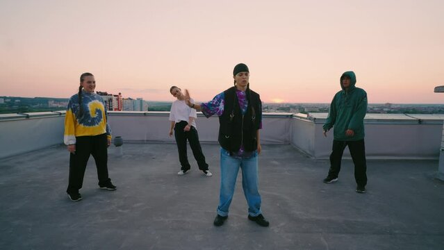 tomboy girl is dancing cool hip-hop dance on roof, teen party with street dancing, hobby and entertainment
