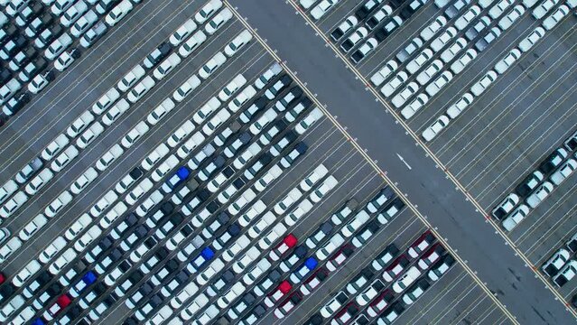 Top view of many cars at the parking lots, new cars lined up. import and export industry. automotive industry. aerial view from drones. 4K
