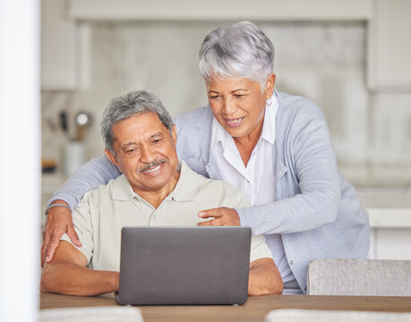 Retirement, laptop and senior couple on the internet reading an email or news via a social network website. Happy elderly woman with a relaxed husband streaming or browsing online at home