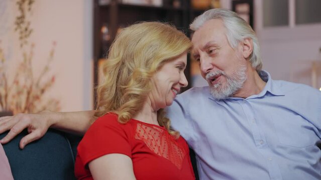 Senior man saying compliments to beloved woman, couple touching foreheads