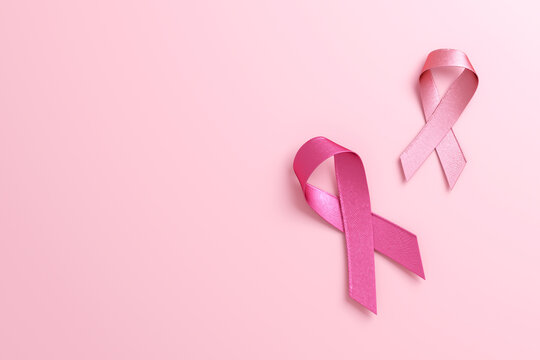 Two pink ribbons isolated on a pink background with copy space for Breast Cancer Awareness Month and World Cancer day. Flyer, banner design template in 3D illustration