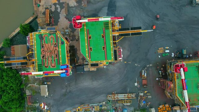 4K : Drones are flying over a large steel plant during cloudy day, many machines are working, exterior of a large metallurgical plant. steel industry. infrastructure industry
