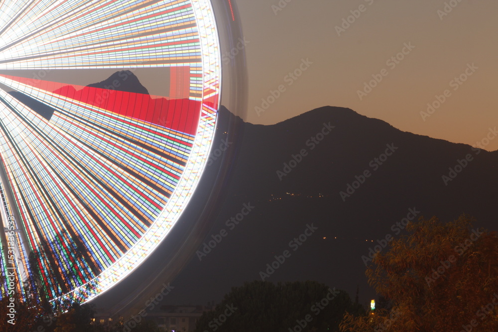 Wall mural Ferris wheel in Antalya night with blurred lights lines