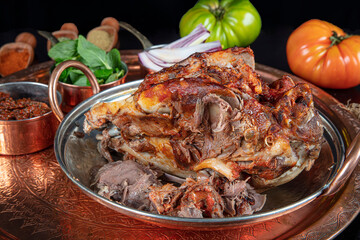 Roasting head of a lamb. Traditional Turkish Offal Food Kelle Sogus, Lamb Head Meat with Brain...