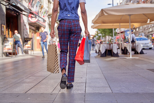 Stylish Man Walking Around Town With Shopping Bags