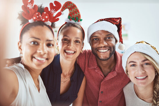 Friends, family and diversity in a Christmas selfie to celebrate the festive season. Black man, women and a happy smile at office xmas party. Team celebration and taking a holiday photo.