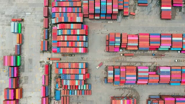 4K : Aerial view from a drone flying over a many cargo containers at distribution center. import and export industry. transportation concept
