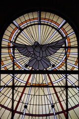 Stained glass window depicting a white dove