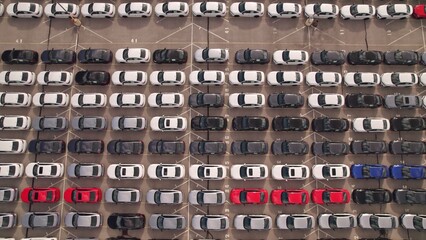 New hybrid EV cars stock parking. Aerial of parking lot of brand new cars for sale and...