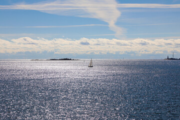 Sailboat on the sparkling waters of the Baltic sea  - obrazy, fototapety, plakaty