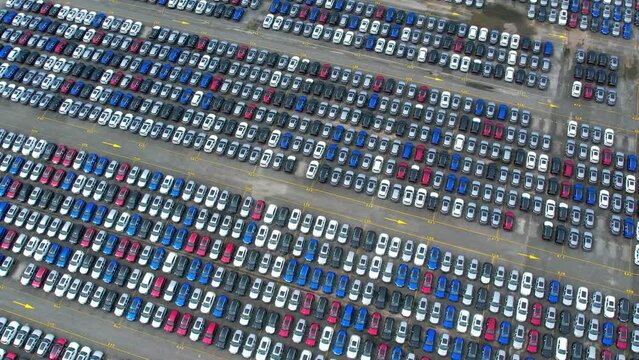 4K : Aerial view of the parked new cars in giant factory. automotive industry. drones footage
