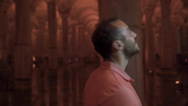 Tourist looking around with smile.
Tourist walking in a historical place with columns. Istanbul Basilica Cistern.
