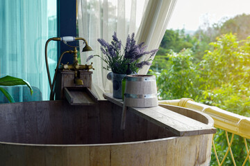 wooden soaking tub outside the hotel balcony for the guests to soak in the fresh air and view the...