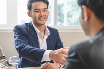 Asian businessman shaking hands with the client  in meeting