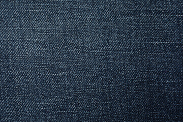Texture of dark blue jeans as background, closeup