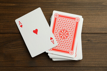 Deck of playing cards on wooden table, top view. Poker game