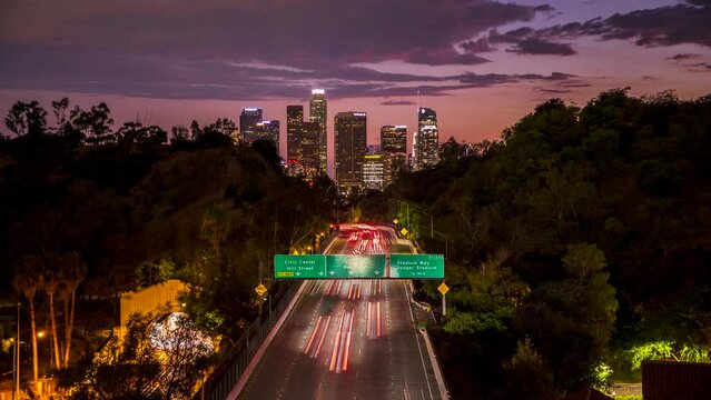 A 4K dusk to night timelapse of the Downtown Los Angeles skyline with cars and traffic heading into LA on the 110 Freeway. 