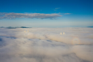 Tops of the pylons of the Golden Bridge in the dawn fog in Vladivostok