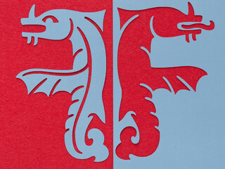 positive and negative forms of fantastical creatures on red fabric