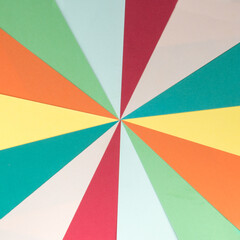 Retro sunburst background made with stripes of colored paper