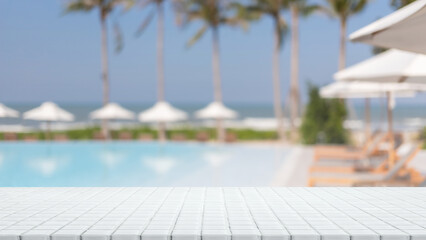 Empty white ceramic mosaic table top and blurred swimming pool in tropical resort in summer banner...