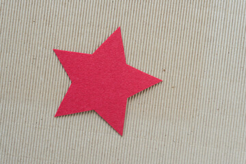 Fototapeta na wymiar isolated material star on corrugated paper