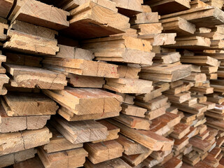 irregularly stacked timber abstract background, Old wooden boards preparing for the construction of...