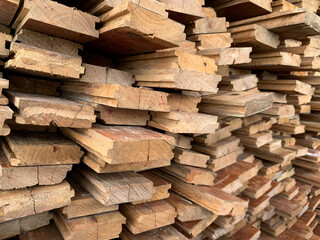 irregularly stacked timber abstract background, Old wooden boards preparing for the construction of the house, Pattern on the edge of several pieces of wood.mobile photo