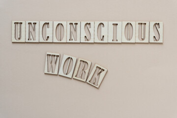 Fototapeta na wymiar unconscious work - sign with wood type