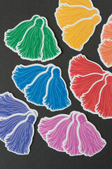 colorful ornamental halftone tassels arranged on a dark background
