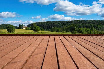 Nature landscape. Wooden platform in picturesque place. Old wooden table in front of nature. Plank platform with blue summer sky. Place for displaying goods on wooden table. Board podium in nature