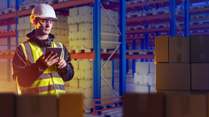 Customs officer man. Guy with boxes in bonded warehouse. Customs check of goods at International border. Customs officer with tablet computer. Man storekeeper in reflective vest. 