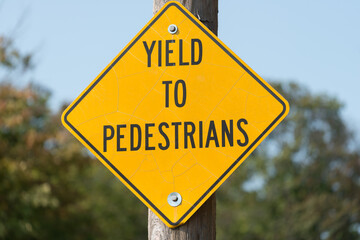 yield to pedestrians - road sign fixed to a pole